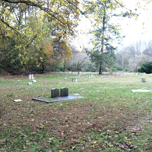 To the left of the entrance, you can see the older, disorganized section of the cemetery. Some of the graves are sunk so deep you cannot read the markers.