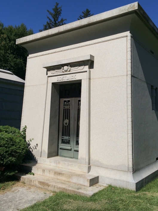 The Bostwick mausoleum features Egyptian motifs such as the winged disc and cobras.